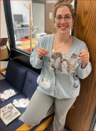 Gabriella Dwork holding up new logo